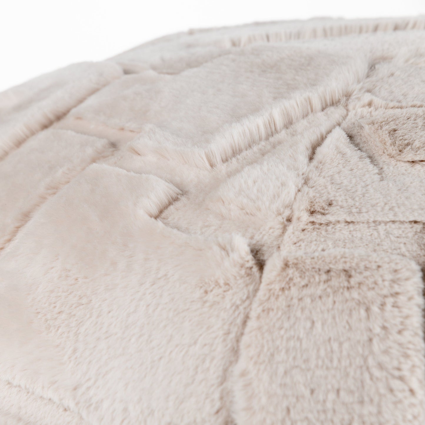 Close-up of the textured beige fabric surface of the Toni cushion pod which is soft and geometric in style