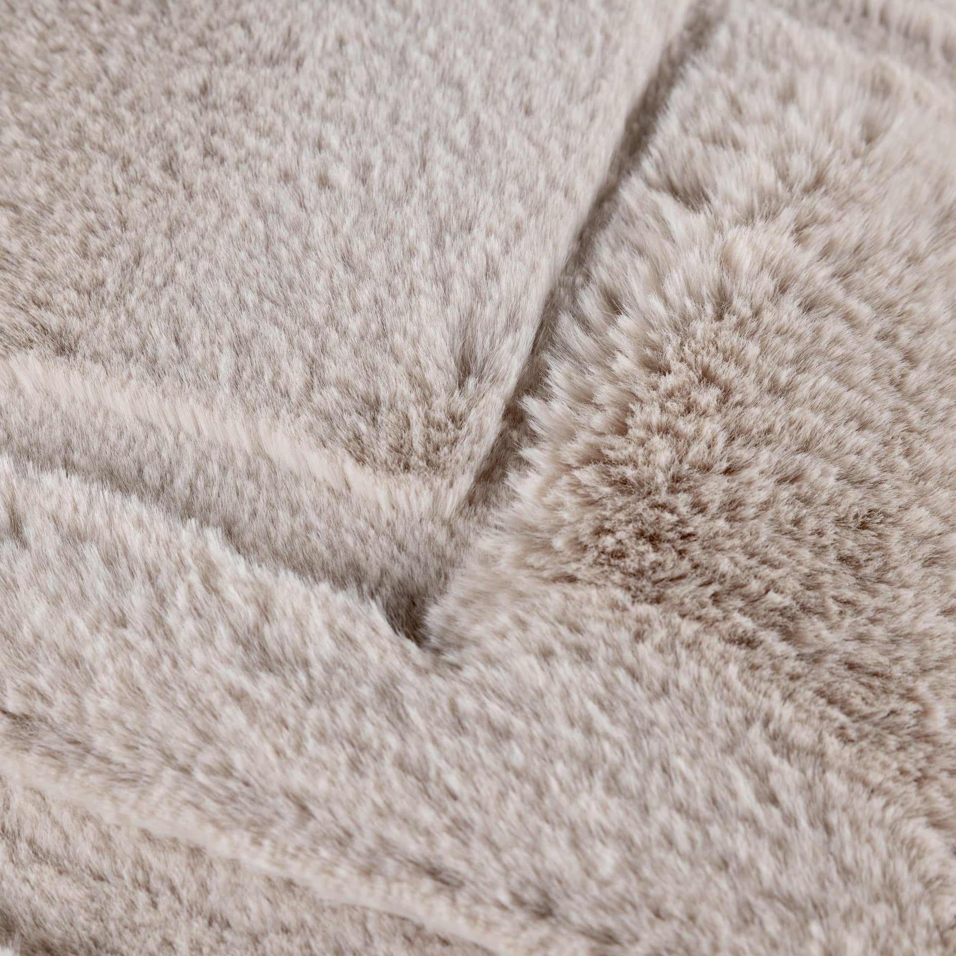Close-up of beige textured fabric with a focus on texture and pattern.