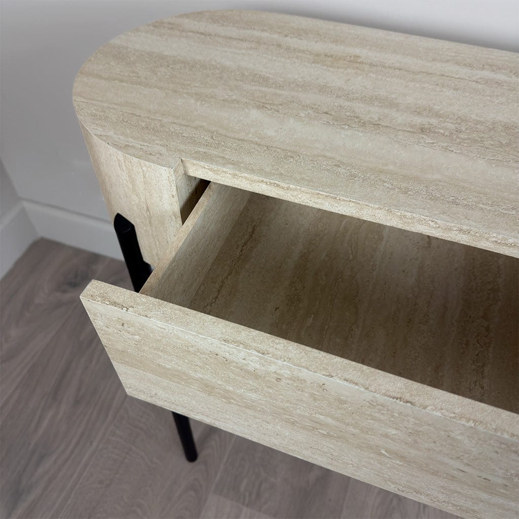Wooden side table with a drawer open on a wooden floor.