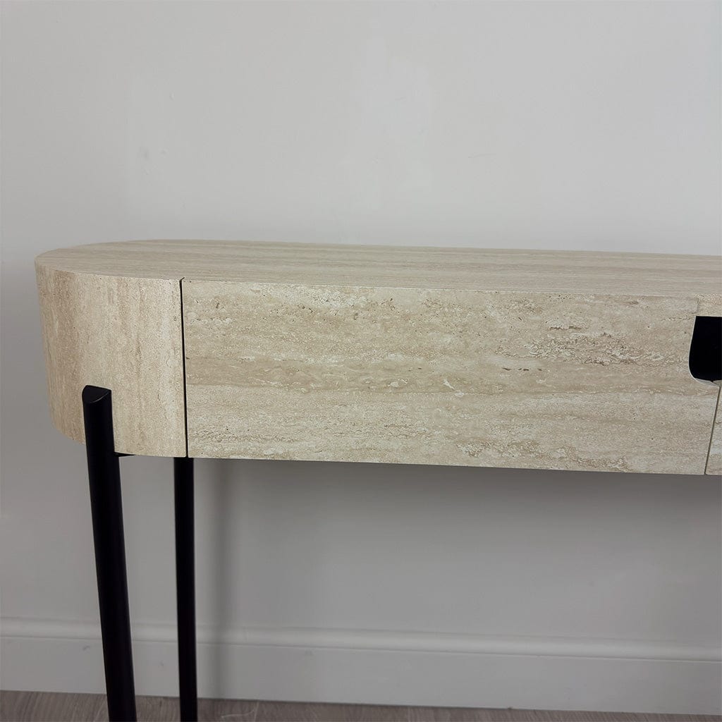 Wooden console table with black legs against a plain wall