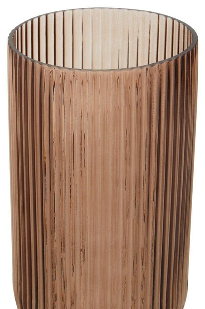 Glass vase with vertical slats on a white background
