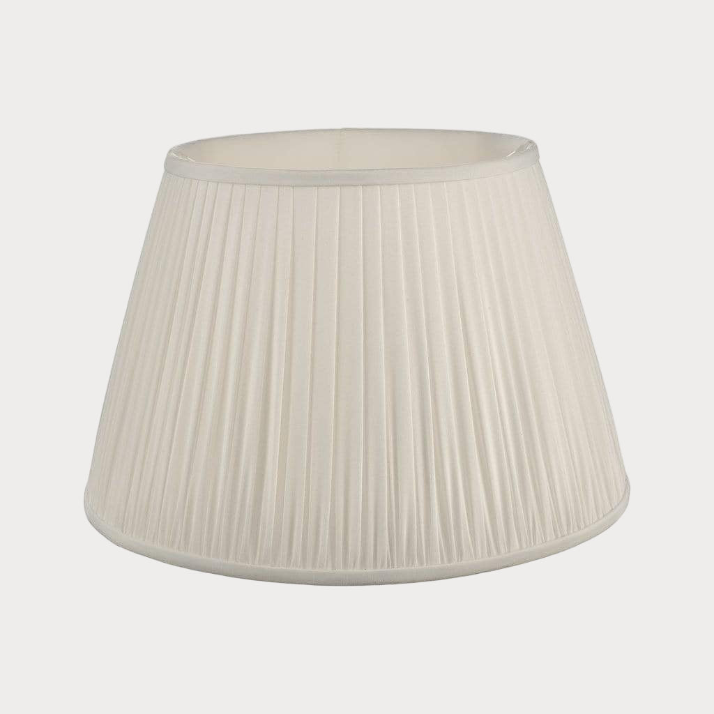 An ivory pleated lampshade with a matching lampshade stand.