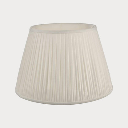 An ivory pleated lampshade with a matching lampshade stand.