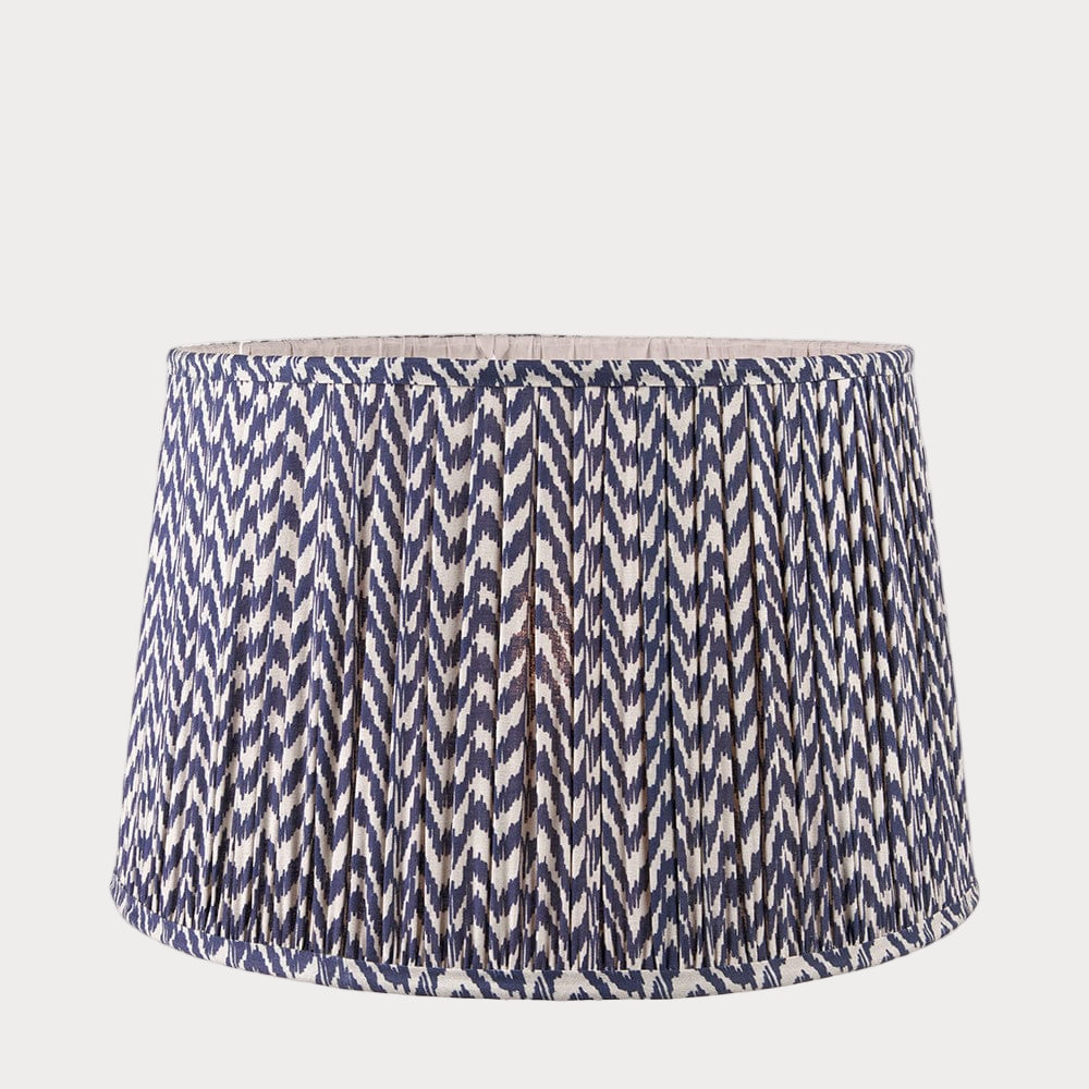 A tapered lamp shade with a zigzag pleated design in a blue and white color scheme.