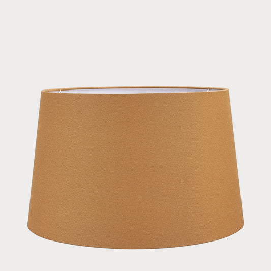 A tapered cylinder shade made of mustard cotton, displayed on a plain background.