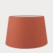 A orange tapered cylinder lampshade made of cotton, designed for use with various lamp bases.