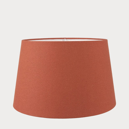 A orange tapered cylinder lampshade made of cotton, designed for use with various lamp bases.