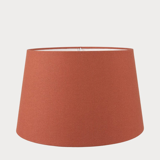 A orange tapered cylinder lampshade made of cotton, designed for use with various lamp bases.
