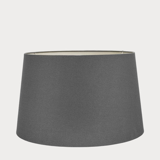 A gray cotton tapered lampshade with a natural finish, displayed on a plain background.