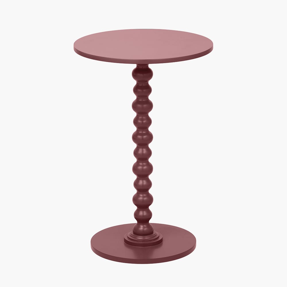 Green round side table with a textured pedestal base on a white background