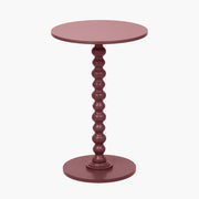 Green round side table with a textured pedestal base on a white background