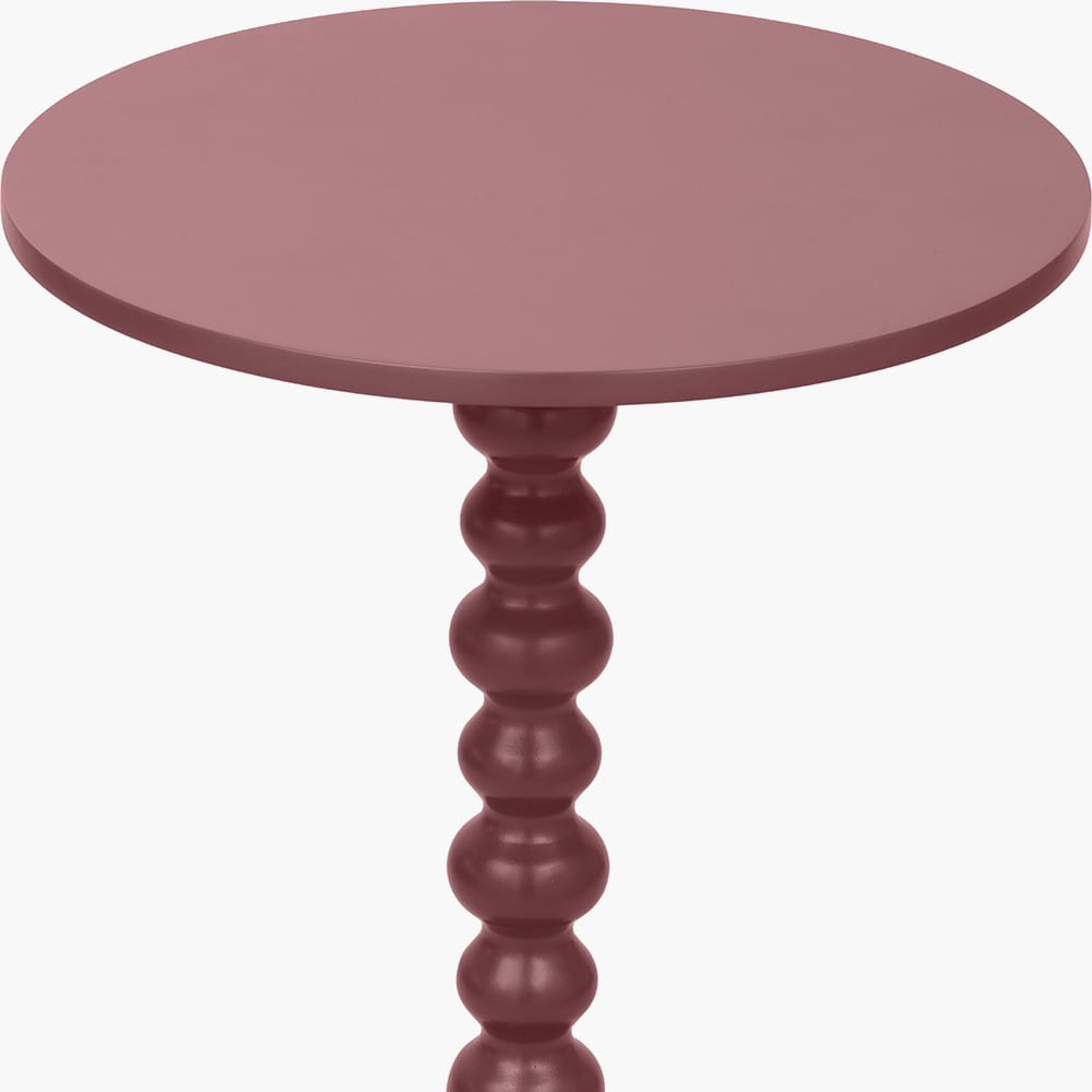 Round pink table with a textured cylindrical leg on a white background