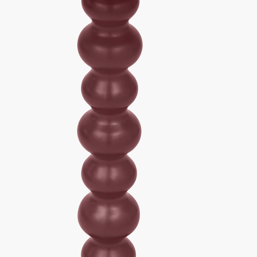 Close-up of a cylindrical object with stacked spherical sections on a white background
