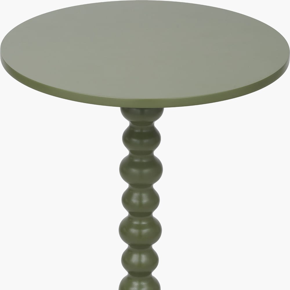 Green round table with a textured pedestal base on a white background
