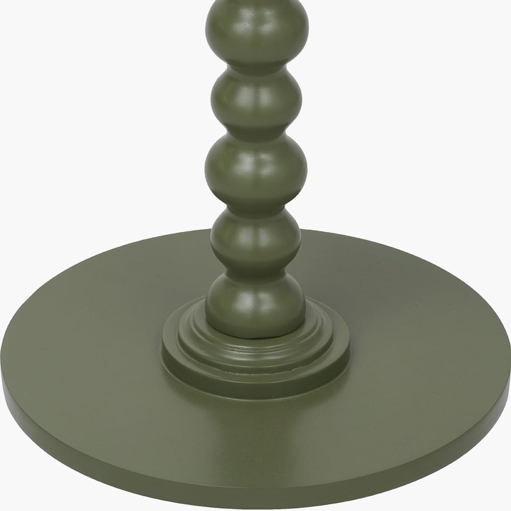 Green candle holder with a textured design on a white background