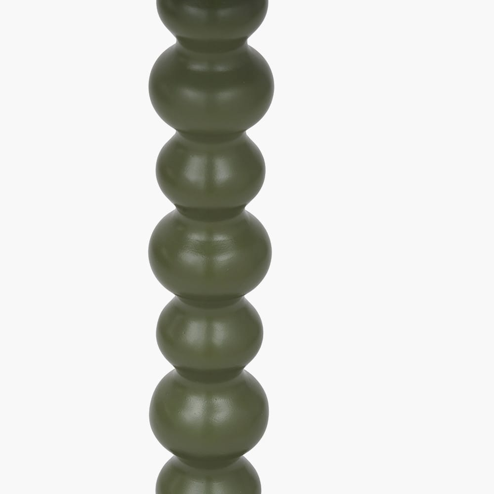 Green cylindrical object with stacked sphere design on a white background