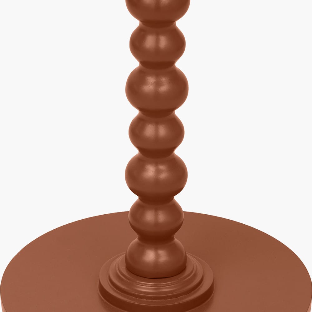Brown candle holder with a textured design on a white background