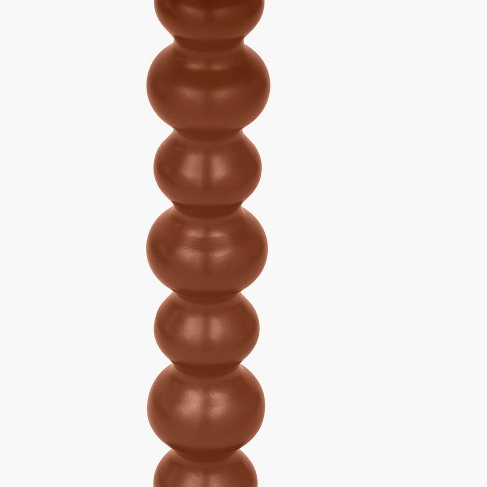 Close-up of a cylindrical object with stacked spherical sections on a white background