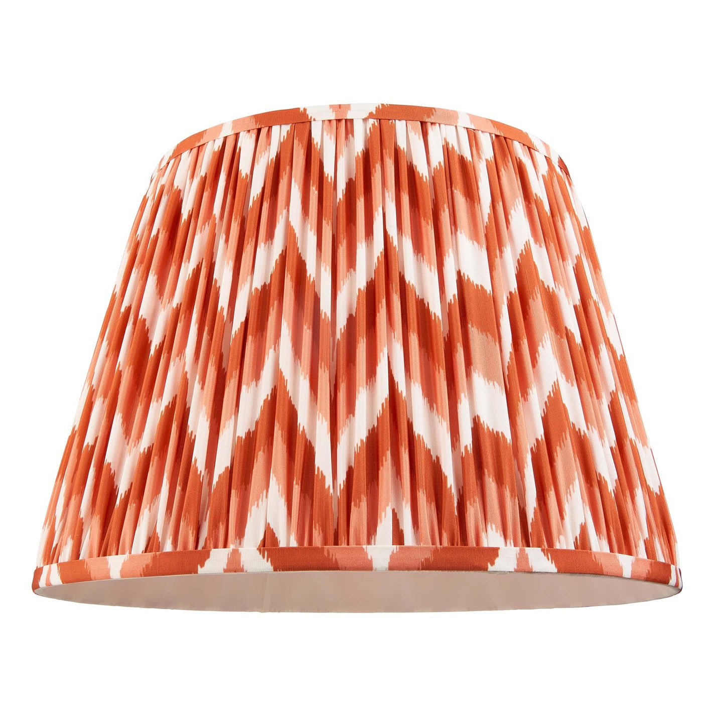 Lampshade with orange and white chevron pattern on a white background