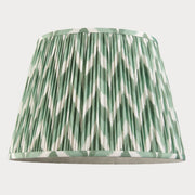 Green and white patterned lampshade on a white background