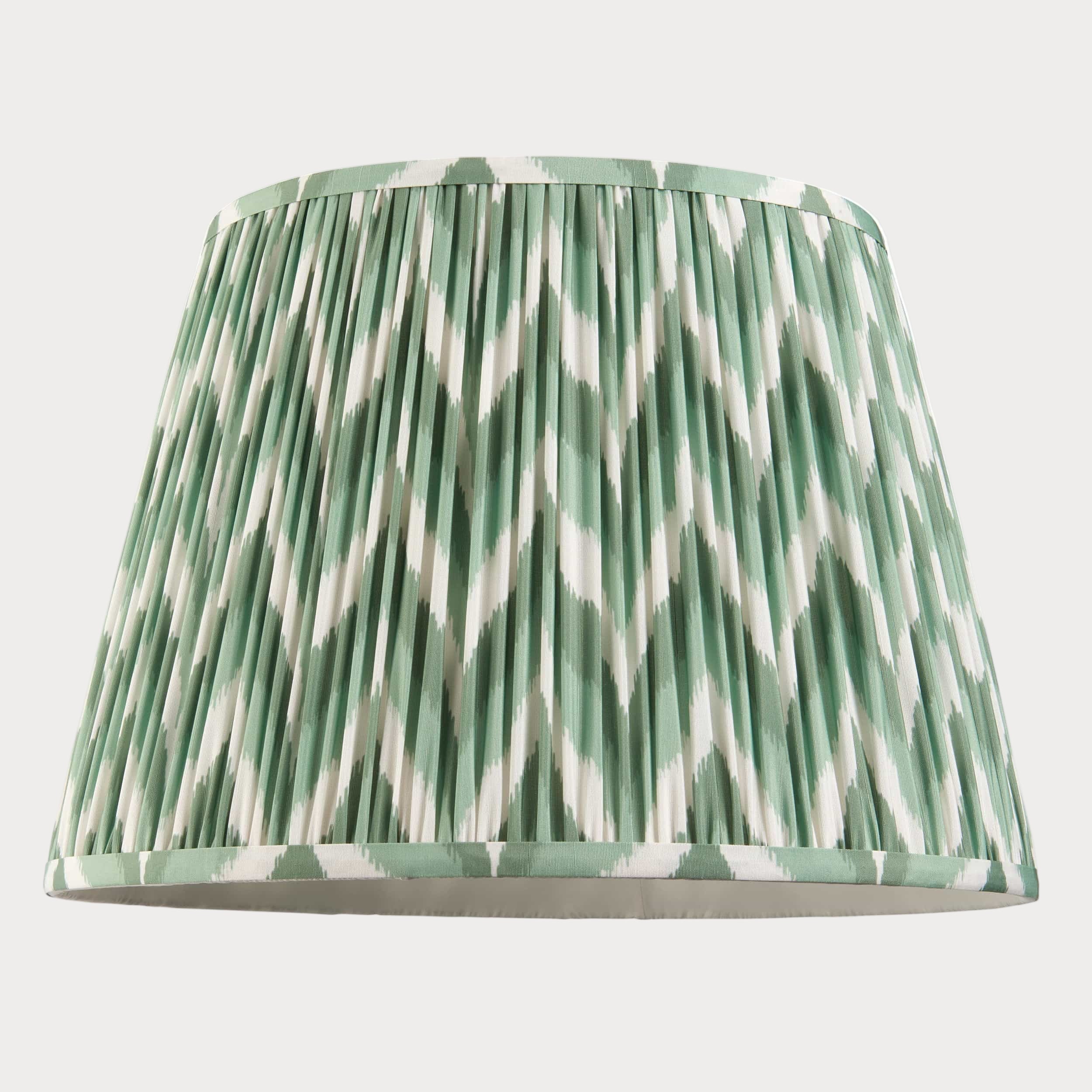 Green and white patterned lampshade on a white background