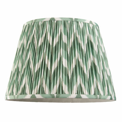 Green and white patterned lampshade on a white background