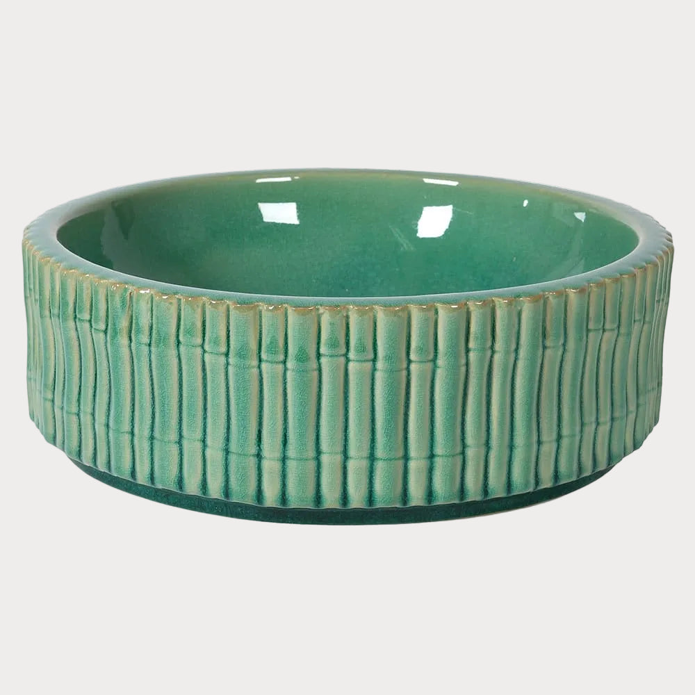 A soft aqua green ceramic bowl with a bamboo style exterior.