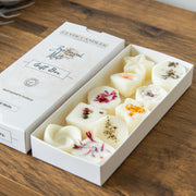 Gift box of Cylindricandles with decorative candles on a wooden surface