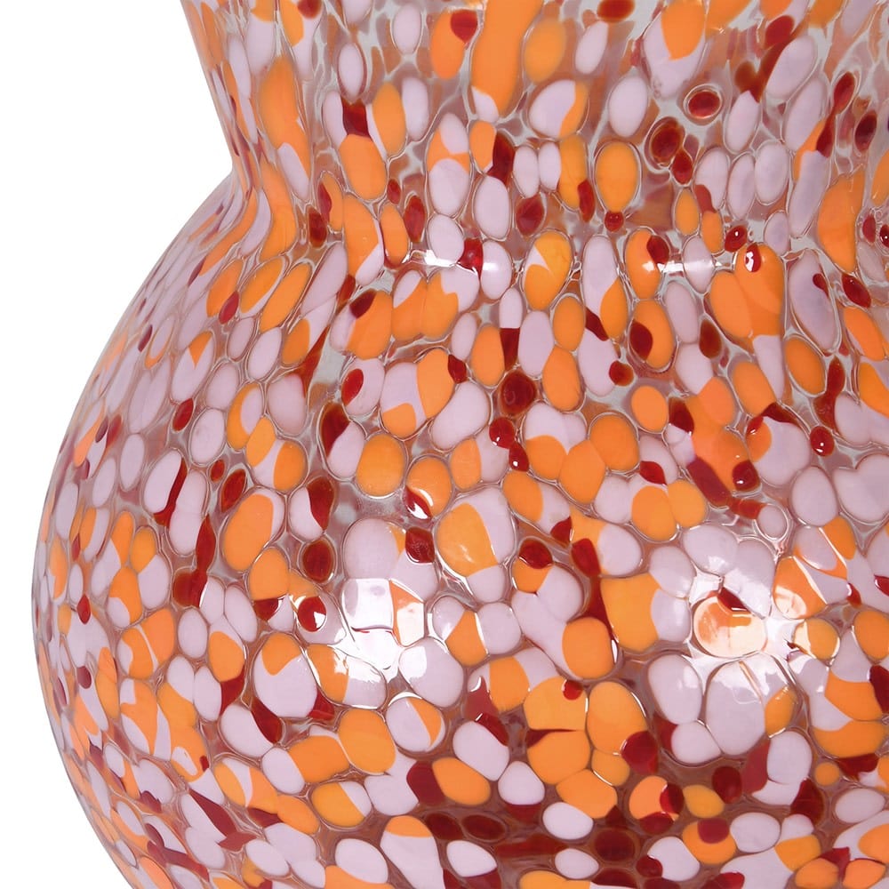 Close up of a bright confetti glass huge with pink, orange and red dots.