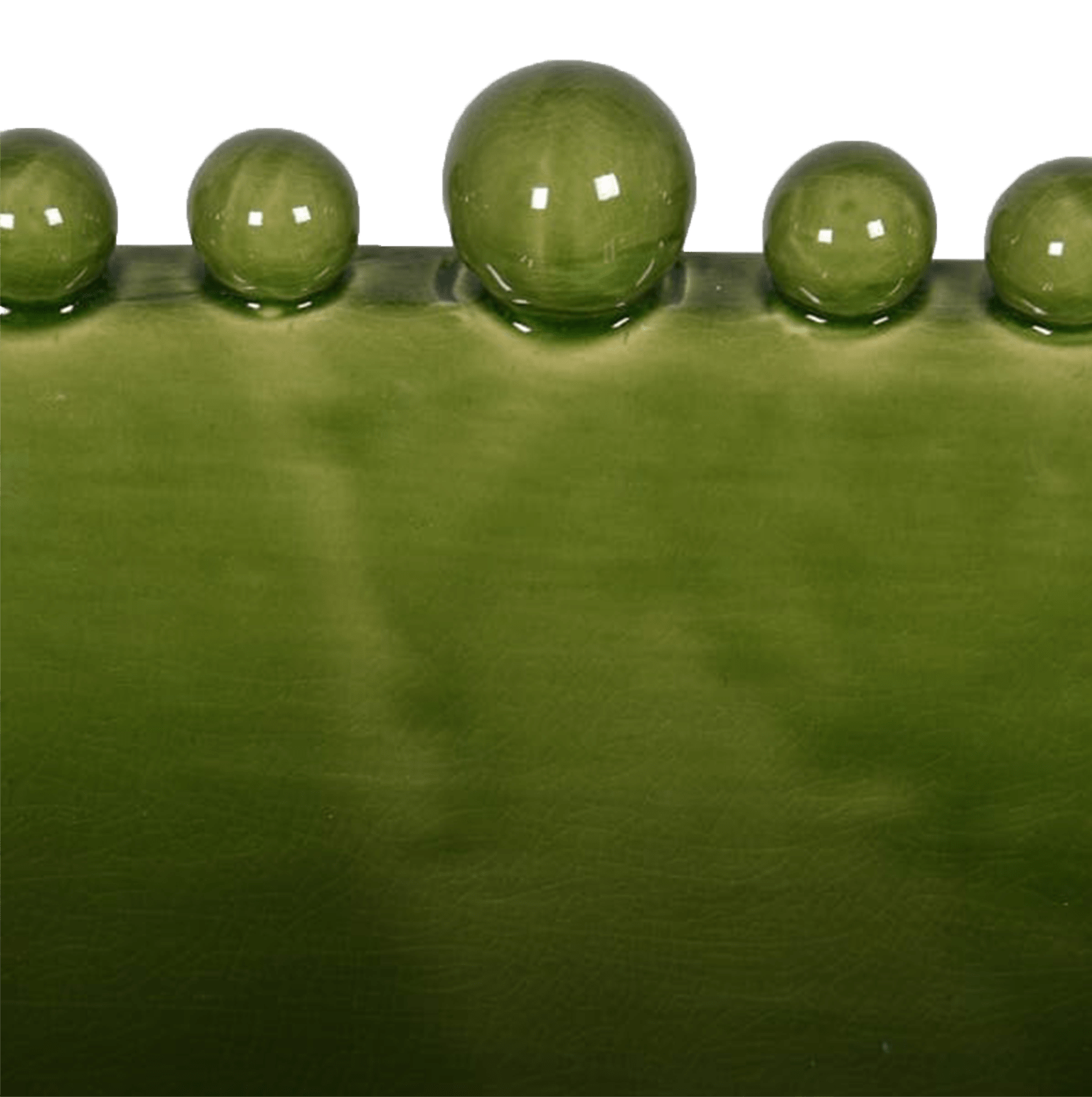 Close up of the edge of a shiny green ceramic bowl with bobbles around the edge