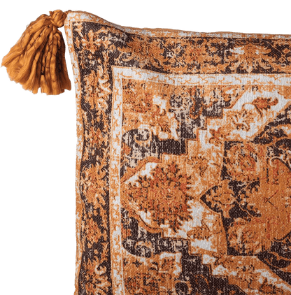 Decorative orange and black pillow with intricate pattern on a plain background