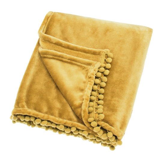 A saffron yellow fleece throw with pom pom trim unfolded and laying on a plain background.