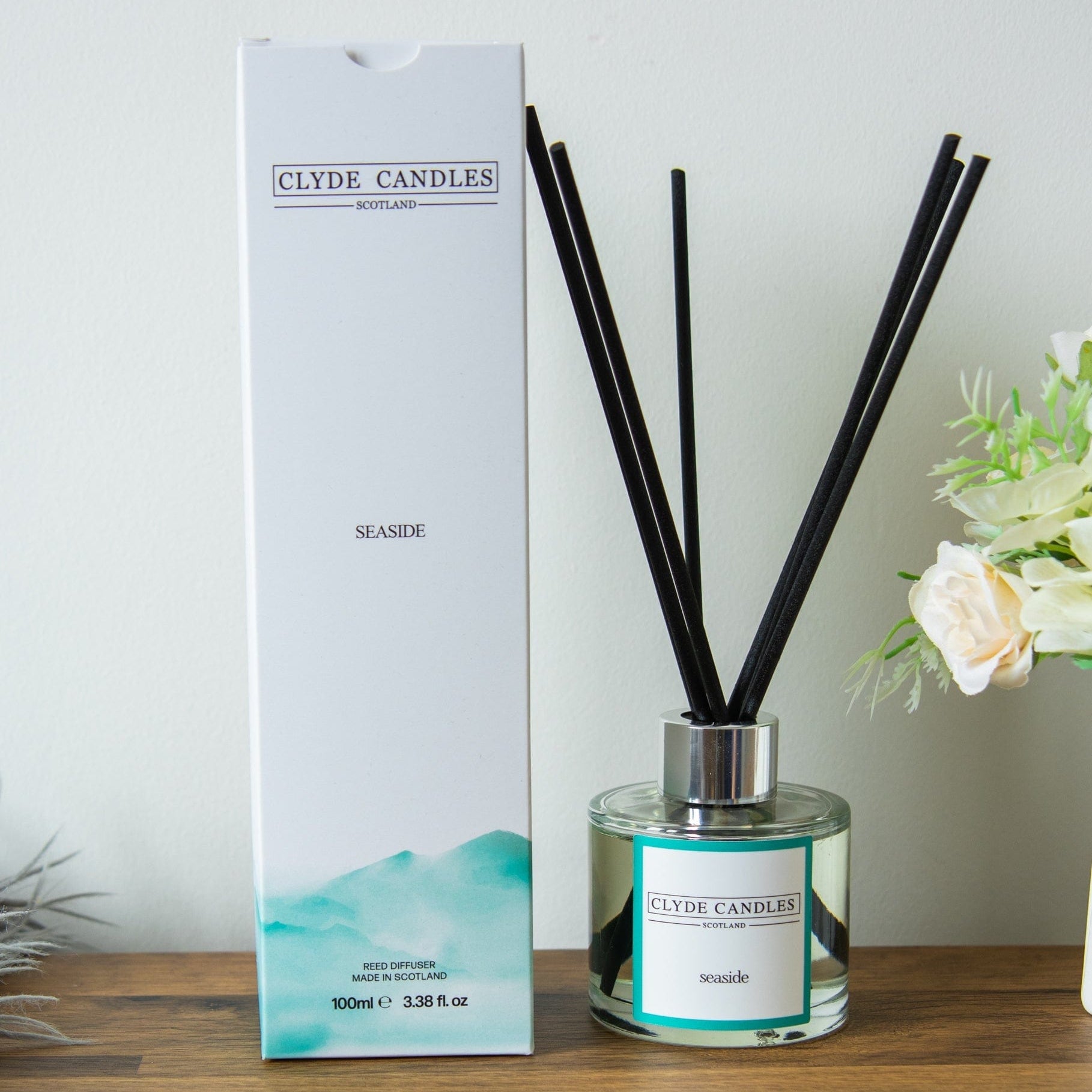 Clyde Candles diffuser with packaging on a wooden surface