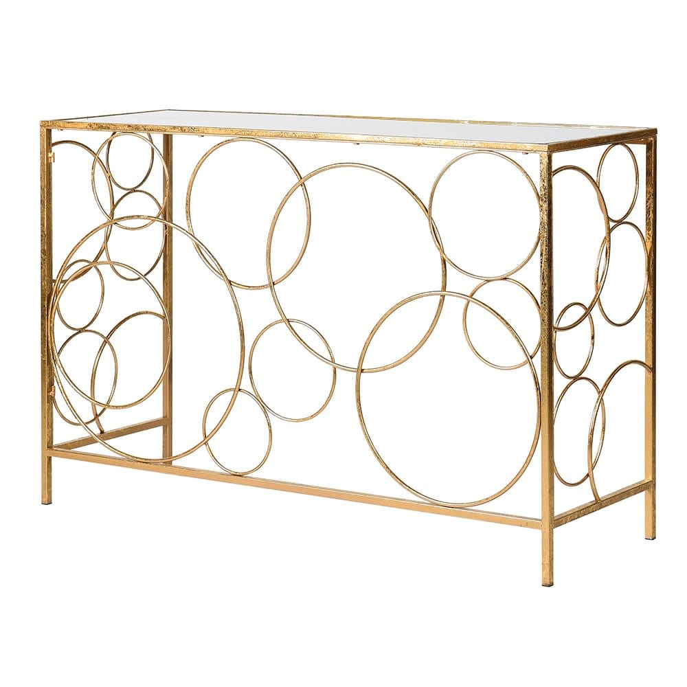 A gold-colored metal console table with a mirrored top and an intricate circular design forming the table structure.