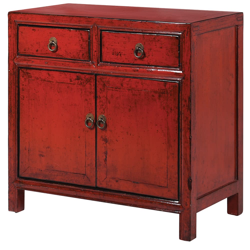 A deep burnt red lacquered wooden cabinet with two drawers and two doors, finished with aged brass handles.