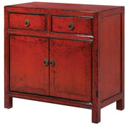 A deep burnt red lacquered wooden cabinet with two drawers and two doors, finished with aged brass handles.