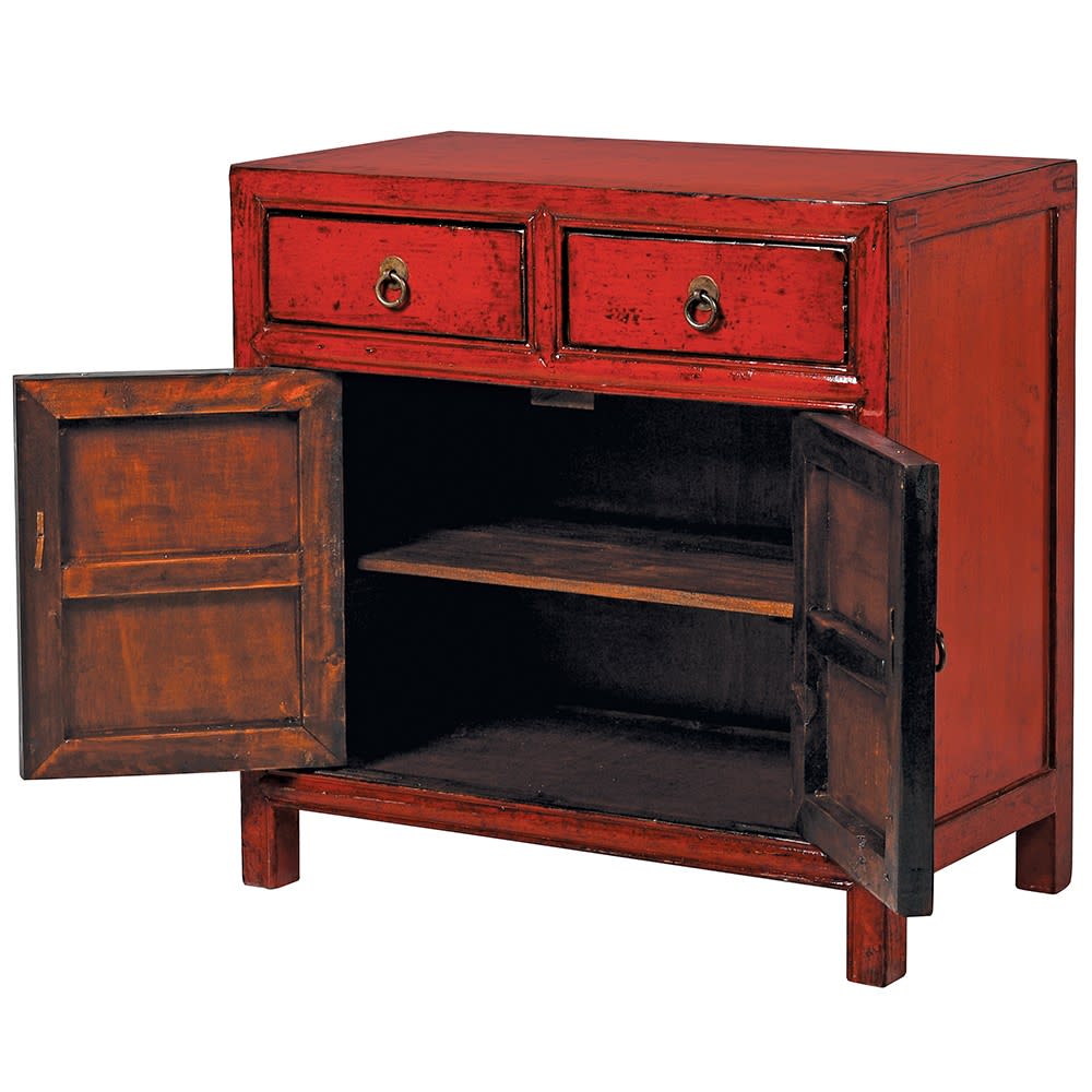 A deep burnt red lacquered wooden cabinet with two drawers and two doors, open to show the dark wooden interior of the cabinet